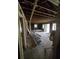 Spacious room under renovation featuring exposed beams, wall studs, and windows with views of the surrounding landscape at 436 W Butternut Rd, Summerville, SC 29483