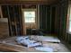 Renovation project showing exposed studs and a window, with materials for updating the house at 436 W Butternut Rd, Summerville, SC 29483