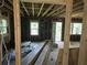 The open-concept room is under construction with exposed beams and new materials at 436 W Butternut Rd, Summerville, SC 29483