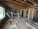 Unfinished room with exposed studs, new electrical wiring, and new windows, highlighting the home's renovation potential at 436 W Butternut Rd, Summerville, SC 29483