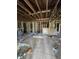 An expansive unfinished space featuring exposed wood beams, wall studs, and the potential for a custom renovation at 436 W Butternut Rd, Summerville, SC 29483