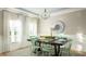 Light-filled dining room with stylish chandelier, decorative mirror and seating for six at 538 Richfield Way, Summerville, SC 29486