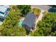 Aerial showing a home with pool, driveway, and tree coverage; featuring a well-maintained property at 607 Jungle Rd, Edisto Beach, SC 29438
