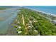 Aerial showing the home's location near both the ocean and a winding waterway, accessible by road at 607 Jungle Rd, Edisto Beach, SC 29438
