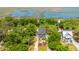 Stunning aerial view of a coastal home featuring a private pool, lush landscaping, and proximity to waterways at 607 Jungle Rd, Edisto Beach, SC 29438