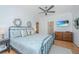 Cozy bedroom includes hardwood floors, ceiling fan, dresser, and decor at 607 Jungle Rd, Edisto Beach, SC 29438