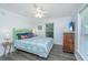 This bedroom features calming paint, coastal decor, ceiling fan and luxury vinyl floors at 607 Jungle Rd, Edisto Beach, SC 29438