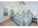 Bright bedroom boasts natural light, hardwood floors, and a ceiling fan at 607 Jungle Rd, Edisto Beach, SC 29438