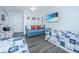 This bright coastal bedroom includes two twin beds, a loveseat, and wall-mounted flat-screen television at 607 Jungle Rd, Edisto Beach, SC 29438