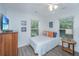 Bright bedroom featuring luxury vinyl floors, ample natural light, and coastal decor at 607 Jungle Rd, Edisto Beach, SC 29438