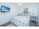 Bedroom has TV, ceiling fan, window, and decor at 607 Jungle Rd, Edisto Beach, SC 29438
