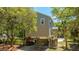 Exterior view of an elevated home, with a garage and under house storage at 607 Jungle Rd, Edisto Beach, SC 29438