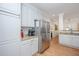 Bright kitchen offers stainless steel refrigerator, ample cabinets and counter space, and hardwood floors at 607 Jungle Rd, Edisto Beach, SC 29438