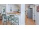 Kitchen and bar area with counter seating and stainless-steel refrigerator at 607 Jungle Rd, Edisto Beach, SC 29438
