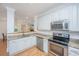 Kitchen boasts stainless steel appliances, granite countertops, white cabinets and an open view at 607 Jungle Rd, Edisto Beach, SC 29438