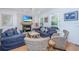 Cozy living room with fireplace, comfortable seating, and natural light at 607 Jungle Rd, Edisto Beach, SC 29438