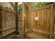 Enclosed wooden outdoor shower featuring both a showerhead and a faucet, perfect for rinsing off after swimming at 607 Jungle Rd, Edisto Beach, SC 29438