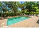 Beautiful backyard pool with lounge chairs is surrounded by lush trees and plants for privacy in this quiet retreat at 607 Jungle Rd, Edisto Beach, SC 29438