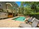A serene backyard pool is surrounded by mature trees and lush greenery, creating a private and inviting outdoor space at 607 Jungle Rd, Edisto Beach, SC 29438