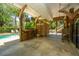 Inviting poolside bar with a shower for rinsing off, wooden bar stools and convenient under-cover entertaining area at 607 Jungle Rd, Edisto Beach, SC 29438