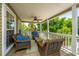 Inviting screened porch with comfortable seating, perfect for relaxing and enjoying the outdoors at 607 Jungle Rd, Edisto Beach, SC 29438