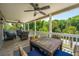 Relaxing covered porch features a table and chairs for outdoor dining and relaxation at 607 Jungle Rd, Edisto Beach, SC 29438
