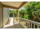 View from a shaded porch showing a glimpse of surrounding trees, offering a peaceful place to relax outdoors at 607 Jungle Rd, Edisto Beach, SC 29438