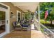 Relaxing porch with wicker furniture and an American flag waving in the breeze at 607 Jungle Rd, Edisto Beach, SC 29438