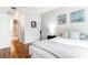 Bright bedroom with hardwood floors, coastal themed decor, and a view to the bathroom at 700 Daniel Ellis Dr # 4107, Charleston, SC 29412