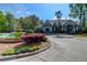 Community clubhouse with lush landscaping, fountain, and ample parking at 700 Daniel Ellis Dr # 4107, Charleston, SC 29412