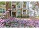 Multi-story condo building with balconies surrounded by mature trees and landscaping at 700 Daniel Ellis Dr # 4107, Charleston, SC 29412
