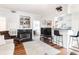 Open-concept living space with hardwood floors, fireplace and kitchen bar at 700 Daniel Ellis Dr # 4107, Charleston, SC 29412