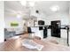 Bright living space with hardwood floors that flows into the kitchen with black appliances at 700 Daniel Ellis Dr # 4107, Charleston, SC 29412