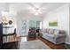 Living room with a sofa and a chair with a doorway to a balcony at 700 Daniel Ellis Dr # 4107, Charleston, SC 29412