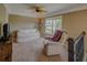 Cozy bedroom with plush seating, a ceiling fan, and a bright window at 8009 Indian Hill Dr, Hanahan, SC 29410
