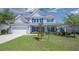 Attractive two-story home with a well-kept lawn, covered front porch and attached two-car garage at 8009 Indian Hill Dr, Hanahan, SC 29410