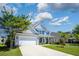 Beautiful home boasts manicured lawn, long driveway, attached garage and inviting front porch at 8009 Indian Hill Dr, Hanahan, SC 29410