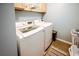 Functional laundry room equipped with modern washer and dryer units and ample storage space at 8009 Indian Hill Dr, Hanahan, SC 29410