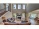 Inviting living room featuring a fireplace, soaring ceilings and plenty of natural light at 8009 Indian Hill Dr, Hanahan, SC 29410