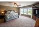 Spacious main bedroom featuring plush carpet, tray ceiling, and large windows providing ample natural light at 8009 Indian Hill Dr, Hanahan, SC 29410