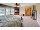 Bright main bedroom featuring large windows, plush carpet, and a ceiling fan for added comfort at 8009 Indian Hill Dr, Hanahan, SC 29410
