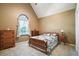 Bedroom with vaulted ceiling, wood furniture, and charming window with curtains at 8661 Laurel Grove Ln, North Charleston, SC 29420