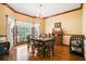 Bright dining area with hardwood floors, chandelier, and adjacent sideboard at 8661 Laurel Grove Ln, North Charleston, SC 29420