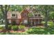 Charming two-story brick home with well-manicured lawn, mature trees and inviting front porch at 8661 Laurel Grove Ln, North Charleston, SC 29420