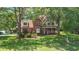 Traditional brick home with a welcoming front porch, mature landscaping, and a lush green lawn at 8661 Laurel Grove Ln, North Charleston, SC 29420