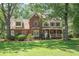 Two-story brick home with dormer windows, a front porch, mature trees, and a well-maintained lawn at 8661 Laurel Grove Ln, North Charleston, SC 29420
