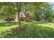 Spacious two-story brick home with a well-manicured lawn, driveway and mature trees at 8661 Laurel Grove Ln, North Charleston, SC 29420
