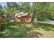 Beautiful brick home with an attached garage and mature landscaping, showcasing curb appeal at 8661 Laurel Grove Ln, North Charleston, SC 29420