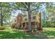 Inviting two-story brick home with a front porch, shutters, and mature landscaping at 8661 Laurel Grove Ln, North Charleston, SC 29420
