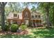 Two-story brick home with a charming front porch, shutters, and mature landscaping at 8661 Laurel Grove Ln, North Charleston, SC 29420